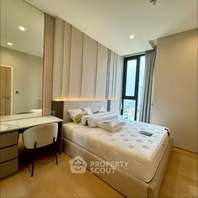 Modern bedroom with elegant design, featuring a cozy bed and stylish furniture.