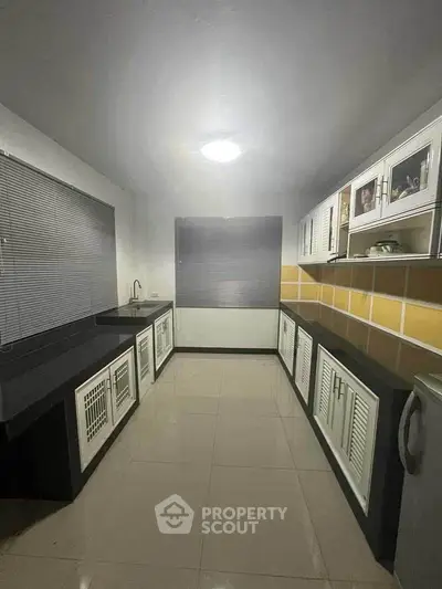 Modern kitchen with sleek black countertops and ample cabinet space