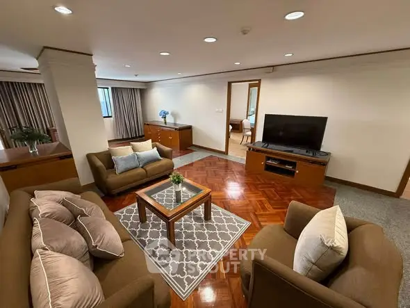 Spacious living room with elegant furniture and modern decor in a luxurious apartment.