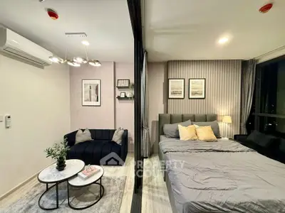 Modern studio apartment with cozy living area and stylish bedroom decor.