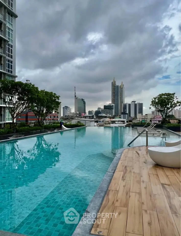 Luxurious rooftop pool with stunning city skyline view, perfect for relaxation and leisure.