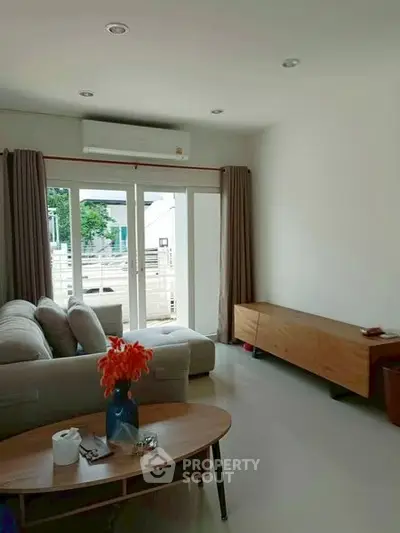 Bright living room with modern sofa and large window view