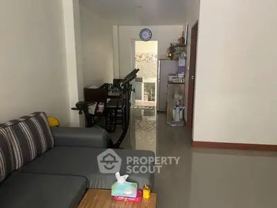 Cozy living room with modern furniture and exercise equipment, perfect for a comfortable lifestyle.