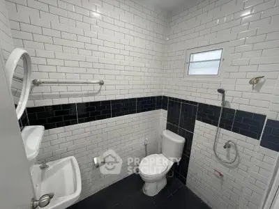 Modern bathroom with white subway tiles and sleek fixtures