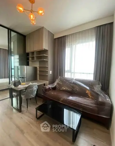 Modern living room with stylish furniture and large windows in a contemporary apartment.