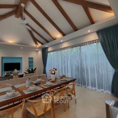 Spacious dining area with elegant decor and large windows in a modern home.
