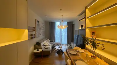 Stylish modern living room with elegant lighting and cozy dining area, perfect for urban living.