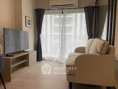 Modern living room with cozy sofa and large TV, featuring floor-to-ceiling windows and elegant curtains.