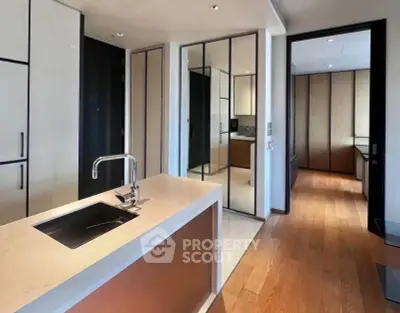 Modern kitchen with sleek design and open layout, featuring a stylish island and high-end finishes.