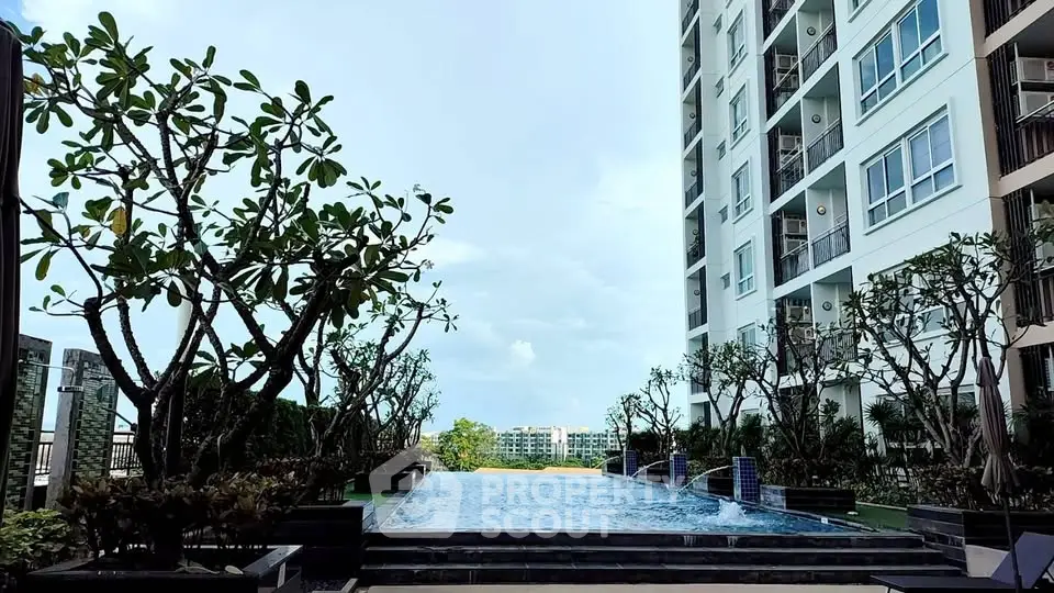 Luxurious condominium with stunning pool and lush greenery, perfect for modern living.