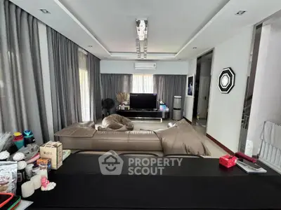 Spacious modern living room with elegant decor and ample natural light, perfect for relaxation and entertainment.