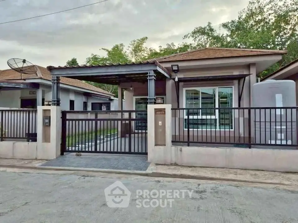 Charming single-story house with gated entrance and modern design in a serene neighborhood.