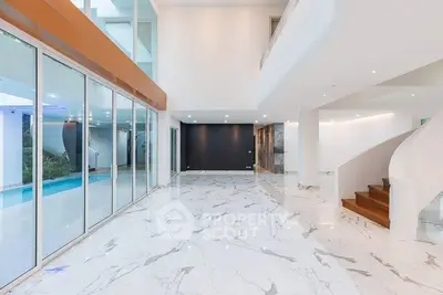 Luxurious modern living room with marble flooring and pool view