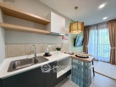 Modern kitchen with open layout and stylish dining area, featuring sleek cabinetry and natural light.