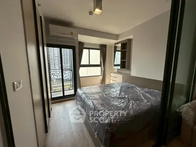 Modern bedroom with balcony view in high-rise apartment