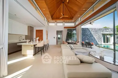Luxurious open-plan living room with pool view and modern kitchen