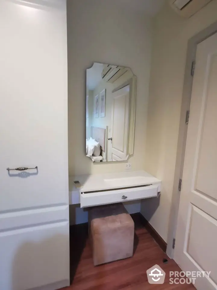 Cozy bedroom corner with elegant vanity and mirror in modern apartment