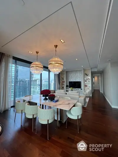 Luxurious modern living room with city view, elegant chandeliers, and stylish dining area.