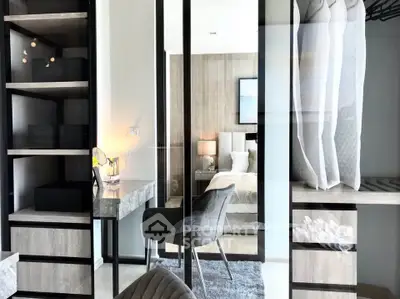 Modern bedroom with stylish furniture and walk-in closet, featuring sleek design and elegant decor.
