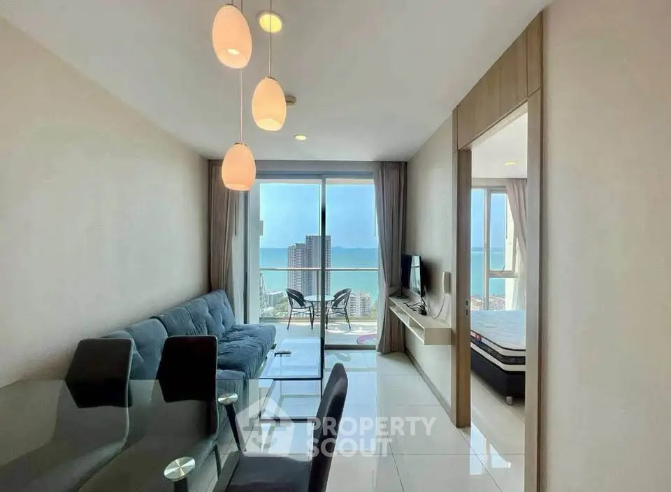Modern living room with ocean view and elegant furnishings in a high-rise apartment.