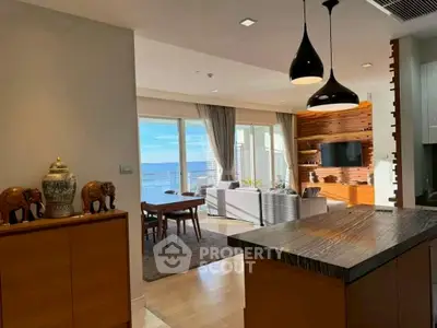 Luxurious open-plan living room with ocean view and modern decor