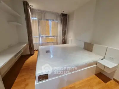 Modern bedroom with large bed and natural light in stylish apartment