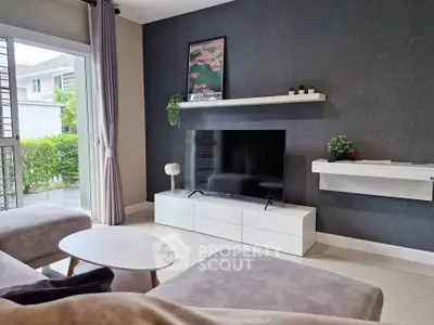 Modern living room with sleek TV unit and large window view