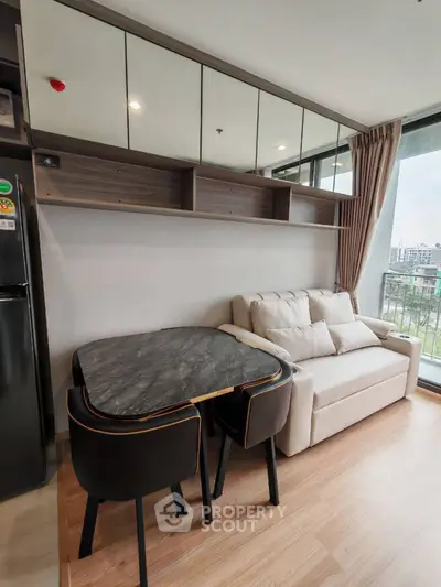 Modern living room with sleek furniture and city view balcony