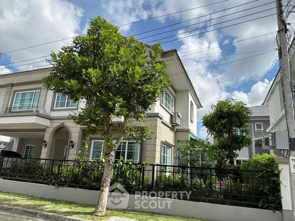 Charming two-story house with lush garden and modern design, perfect for family living.