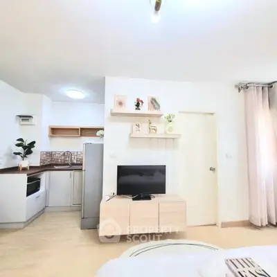 Modern studio apartment with stylish decor and open kitchen layout