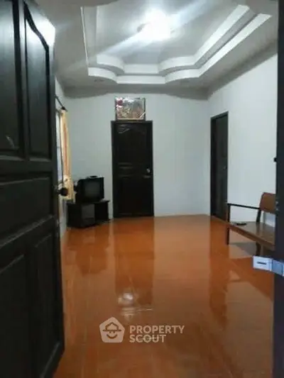 Spacious interior hallway with glossy tiled floor and modern ceiling design.