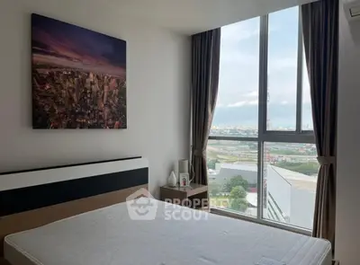 Modern bedroom with large window offering stunning city view, featuring minimalist decor and cozy ambiance.