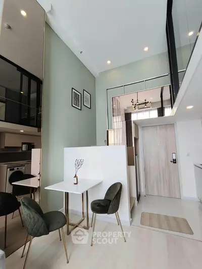 Modern loft apartment with high ceilings and stylish decor, featuring a cozy dining area and mezzanine level.