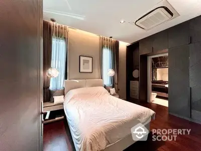 Luxurious bedroom with elegant decor and soft lighting, featuring a cozy bed and modern design.