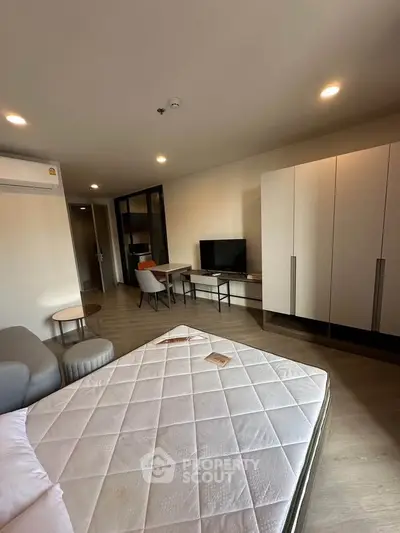Modern bedroom with stylish furniture and natural lighting, featuring a comfortable bed and sleek wardrobe.