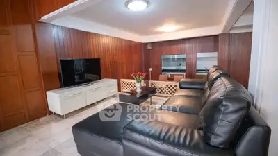 Spacious living room with modern leather sofa and sleek entertainment center
