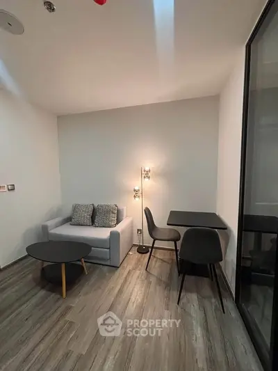 Modern living room with sleek furniture and stylish lighting in a cozy apartment.