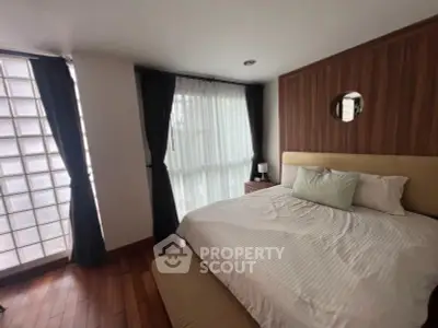 Cozy bedroom with modern decor and large windows for natural light