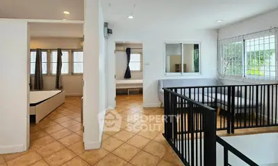 Spacious interior with tiled floors and natural light, featuring a cozy living area and bedroom.