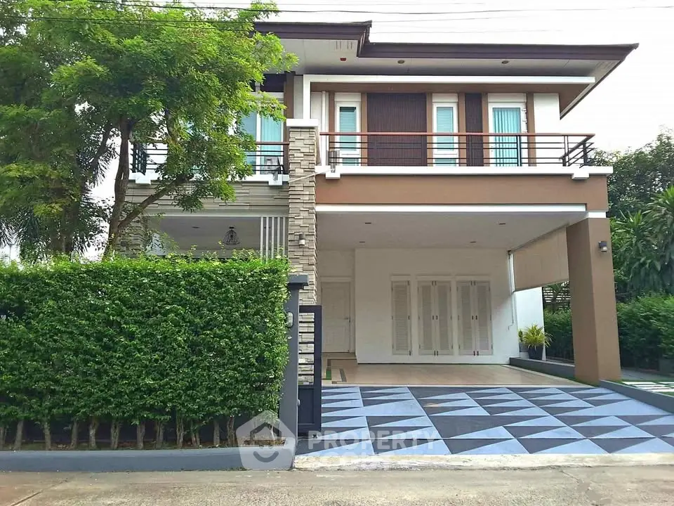 Modern two-story house with spacious driveway and lush greenery