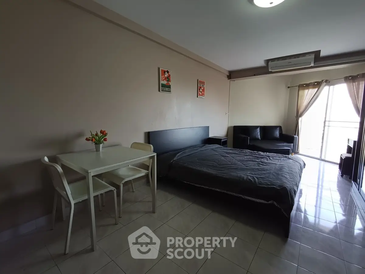Spacious studio apartment with modern furnishings and natural light.