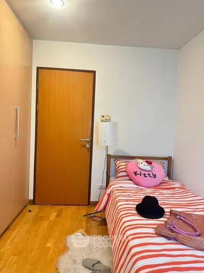 Cozy bedroom with wooden flooring and stylish decor