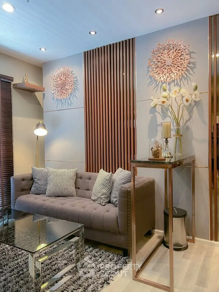 Luxurious living room with modern decor, plush sofa, and elegant lighting in a stylish apartment.