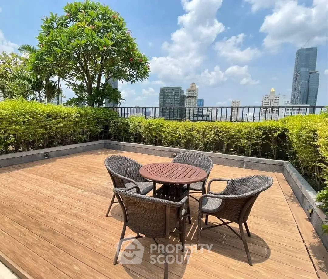 Stunning rooftop terrace with city skyline views and cozy seating area.
