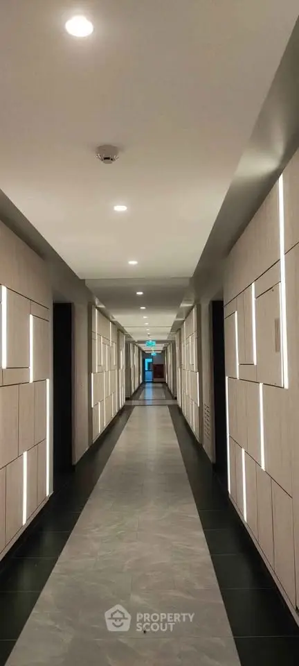 Modern hallway with sleek lighting and contemporary design in upscale building.