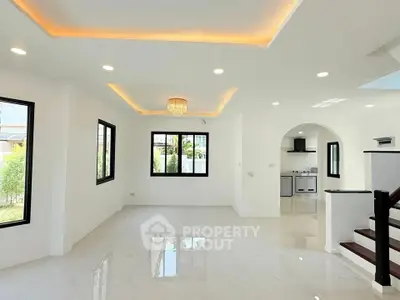 Spacious modern living room with elegant lighting and large windows