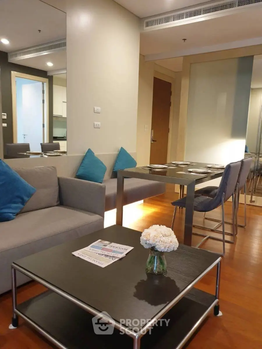 Modern living room with dining area, stylish furniture, and cozy ambiance in a contemporary apartment.