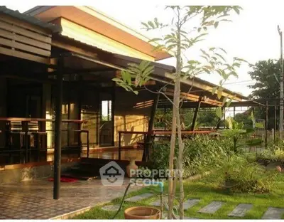 Charming modern home with lush garden and spacious patio, perfect for outdoor relaxation.
