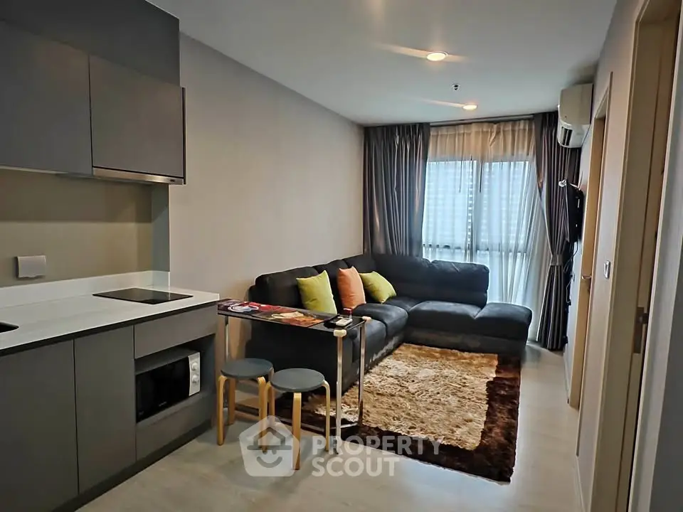 Modern living room with sleek furniture and cozy ambiance in a stylish apartment.