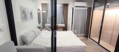 Modern bedroom with cozy decor and large windows for natural light